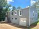 Renovated home features gray siding, a backyard garage, and an upstairs entrance at 2039 Gober Ave Se, Smyrna, GA 30080