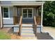 Inviting front porch with wood columns and a stylish hanging light fixture at 2039 Gober Ave Se, Smyrna, GA 30080