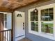 Exterior front porch with a stylish hanging light fixture, and wood railing at 2039 Gober Ave Se, Smyrna, GA 30080