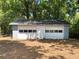Detached two-car garage with gray and white paint and two garage doors at 2039 Gober Ave Se, Smyrna, GA 30080