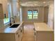 Bright kitchen features white counters and cabinets, updated fixtures and a view into the adjacent dining area at 2039 Gober Ave Se, Smyrna, GA 30080