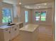 Bright open kitchen area features quartz counters, island, updated fixtures and a view into the breakfast area at 2039 Gober Ave Se, Smyrna, GA 30080