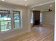 Bright Living Room features a modern fireplace and large windows overlooking the front yard at 2039 Gober Ave Se, Smyrna, GA 30080