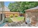 Inviting backyard with well-kept lawn, patio area, seating, and partially shaded by mature trees at 3347 Sable Run Rd, Atlanta, GA 30349