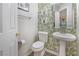 Charming half-bathroom with a pedestal sink and attractive wallpaper at 3347 Sable Run Rd, Atlanta, GA 30349