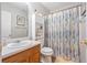 Well-lit bathroom featuring a single sink vanity, framed mirror, and shower with stylish curtain at 3347 Sable Run Rd, Atlanta, GA 30349