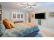 Bedroom showcases a ceiling fan, television, stylish decor, and a cozy bed for a welcoming retreat at 3347 Sable Run Rd, Atlanta, GA 30349
