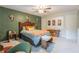 This bedroom features decorative wallpaper, a ceiling fan, accent decorations and a comfortable bed at 3347 Sable Run Rd, Atlanta, GA 30349
