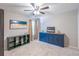 Charming bedroom with plush carpeting, a ceiling fan, and blue built-in storage cabinets at 3347 Sable Run Rd, Atlanta, GA 30349