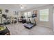 Bright bonus room featuring wood-look floors, natural light, ceiling fan, and versatile space for office or workout at 3347 Sable Run Rd, Atlanta, GA 30349