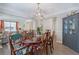Charming dining room features a glossy table, stylish chairs, a modern chandelier, and a charming hutch at 3347 Sable Run Rd, Atlanta, GA 30349
