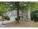 Attractive two-story home featuring gray siding, white trim, a two-car garage and mature trees at 3347 Sable Run Rd, Atlanta, GA 30349