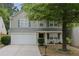 Charming two-story home with a well-maintained lawn, a two-car garage, and tasteful landscaping at 3347 Sable Run Rd, Atlanta, GA 30349