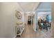 Bright hallway featuring hardwood floors, decorative ceiling, and views of the living and dining rooms at 3347 Sable Run Rd, Atlanta, GA 30349
