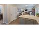 Open concept kitchen with breakfast bar offering seamless flow into the bright and inviting living room at 3347 Sable Run Rd, Atlanta, GA 30349