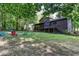 Private backyard with a fire pit, outdoor seating, and a spacious deck for entertaining guests at 3470 Hill Ln, Acworth, GA 30102