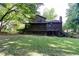 Large backyard features a deck, screened porch, and mature trees, ideal for relaxation and entertaining at 3470 Hill Ln, Acworth, GA 30102