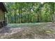 Spacious backyard with trees, fire pit, and outdoor seating area offers a serene, private setting at 3470 Hill Ln, Acworth, GA 30102