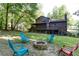 Serene backyard with a fire pit, Adirondack chairs, and large deck for enjoying the outdoors at 3470 Hill Ln, Acworth, GA 30102