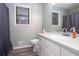Clean bathroom featuring a white vanity with sink, a toilet, and a window at 3470 Hill Ln, Acworth, GA 30102