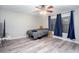 Large bedroom with plank flooring, a ceiling fan, two windows and ample open space at 3470 Hill Ln, Acworth, GA 30102