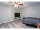 Bedroom showing plank flooring, a ceiling fan, a television, and light gray walls at 3470 Hill Ln, Acworth, GA 30102