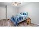 Well-lit bedroom showcasing a ceiling fan, a bed, and light gray walls at 3470 Hill Ln, Acworth, GA 30102