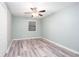 Bedroom featuring natural light, a ceiling fan, and wood laminate flooring at 3470 Hill Ln, Acworth, GA 30102
