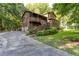 A two-story home with an attached garage, stairs to the front door, and wooded surroundings at 3470 Hill Ln, Acworth, GA 30102