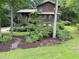 Charming two-story home with brown siding, front porch, and mature landscaping in a wooded setting at 3470 Hill Ln, Acworth, GA 30102