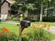 Inviting home exterior featuring a mailbox with floral accents and a view of the attached two-car garage at 3470 Hill Ln, Acworth, GA 30102