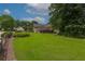 Spacious backyard featuring a lush green lawn and a charming deck, ideal for outdoor gatherings and Gathering enjoyment at 388 Rose Creek Pl, Woodstock, GA 30189