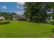 Expansive backyard featuring lush green lawn, mature trees, and a charming deck, perfect for outdoor entertaining at 388 Rose Creek Pl, Woodstock, GA 30189