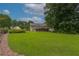 Expansive backyard featuring lush green lawn, mature trees, and a charming deck, perfect for outdoor entertaining at 388 Rose Creek Pl, Woodstock, GA 30189