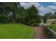 Scenic backyard with a well-maintained lawn, mature trees, and a natural landscape that offers privacy and tranquility at 388 Rose Creek Pl, Woodstock, GA 30189