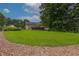 Spacious backyard featuring a lush green lawn and a charming deck, ideal for outdoor gatherings and Gathering enjoyment at 388 Rose Creek Pl, Woodstock, GA 30189