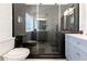 Sleek bathroom boasts a glass shower, with tile surround, and gray vanity at 388 Rose Creek Pl, Woodstock, GA 30189