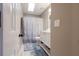 Bathroom with a white vanity, toilet, shower with curtain, and skylight at 388 Rose Creek Pl, Woodstock, GA 30189