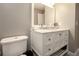 Bathroom featuring a white vanity with a marble countertop and ample storage at 388 Rose Creek Pl, Woodstock, GA 30189