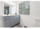 Modern bathroom features gray vanity, white shiplap, and bright natural light at 388 Rose Creek Pl, Woodstock, GA 30189