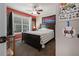 Bedroom features a dark wood bed frame, ceiling fan, and sporty decor at 388 Rose Creek Pl, Woodstock, GA 30189