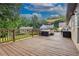 Large wood deck with comfortable lounge seating and outdoor furniture overlooking the backyard at 388 Rose Creek Pl, Woodstock, GA 30189