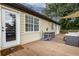 View of the home's deck with outdoor furniture and a barbeque grill with a wooden chair at 388 Rose Creek Pl, Woodstock, GA 30189