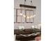 Dining room with a large farmhouse table and unique lighting fixture at 388 Rose Creek Pl, Woodstock, GA 30189