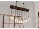 Rustic dining room chandelier with Edison bulbs illuminates the dining area at 388 Rose Creek Pl, Woodstock, GA 30189