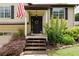 Inviting front porch of a home with a decorative wreath and manicured landscaping at 388 Rose Creek Pl, Woodstock, GA 30189
