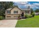 Charming two-story home with a manicured lawn and a two-car garage at 388 Rose Creek Pl, Woodstock, GA 30189