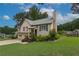 Charming two-story home featuring an attached garage and a lush green lawn at 388 Rose Creek Pl, Woodstock, GA 30189