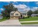 Inviting two-story home with an attached garage, lush lawn, and mature trees at 388 Rose Creek Pl, Woodstock, GA 30189