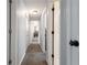 Hallway with multiple doors and a view into the living room fireplace at 388 Rose Creek Pl, Woodstock, GA 30189